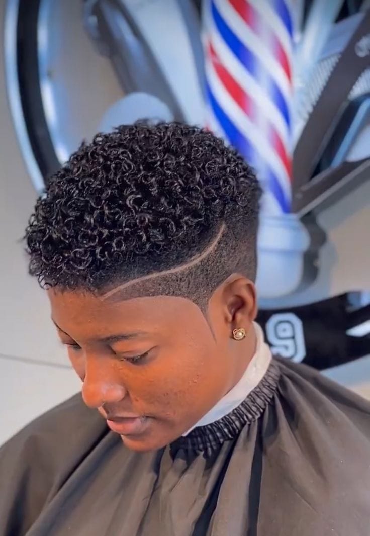 Client with defined curls and a faded taper