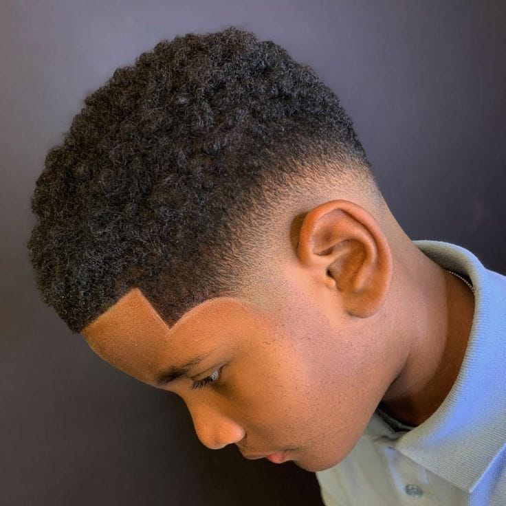 Child receiving a precise haircut at the barbershop